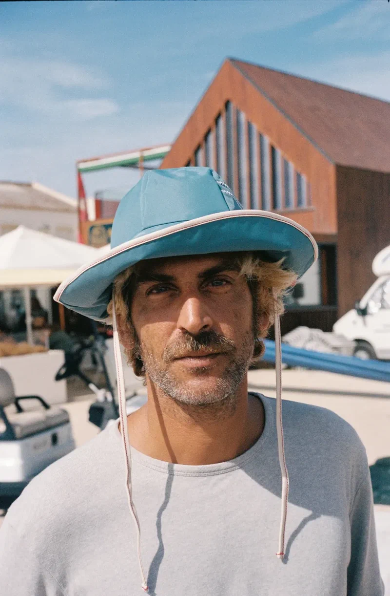 Portrait of a man in a pale blue bucket hat