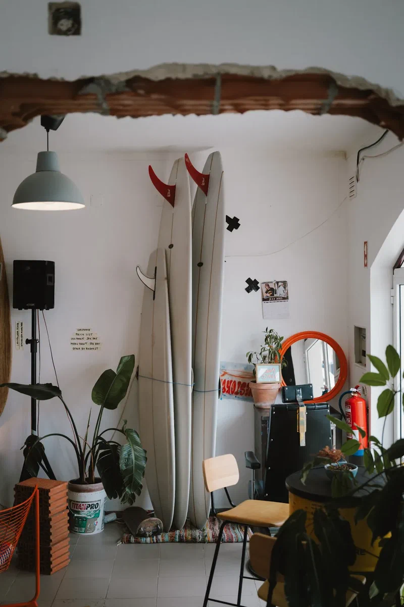Two surfboards standing in a café with plants
