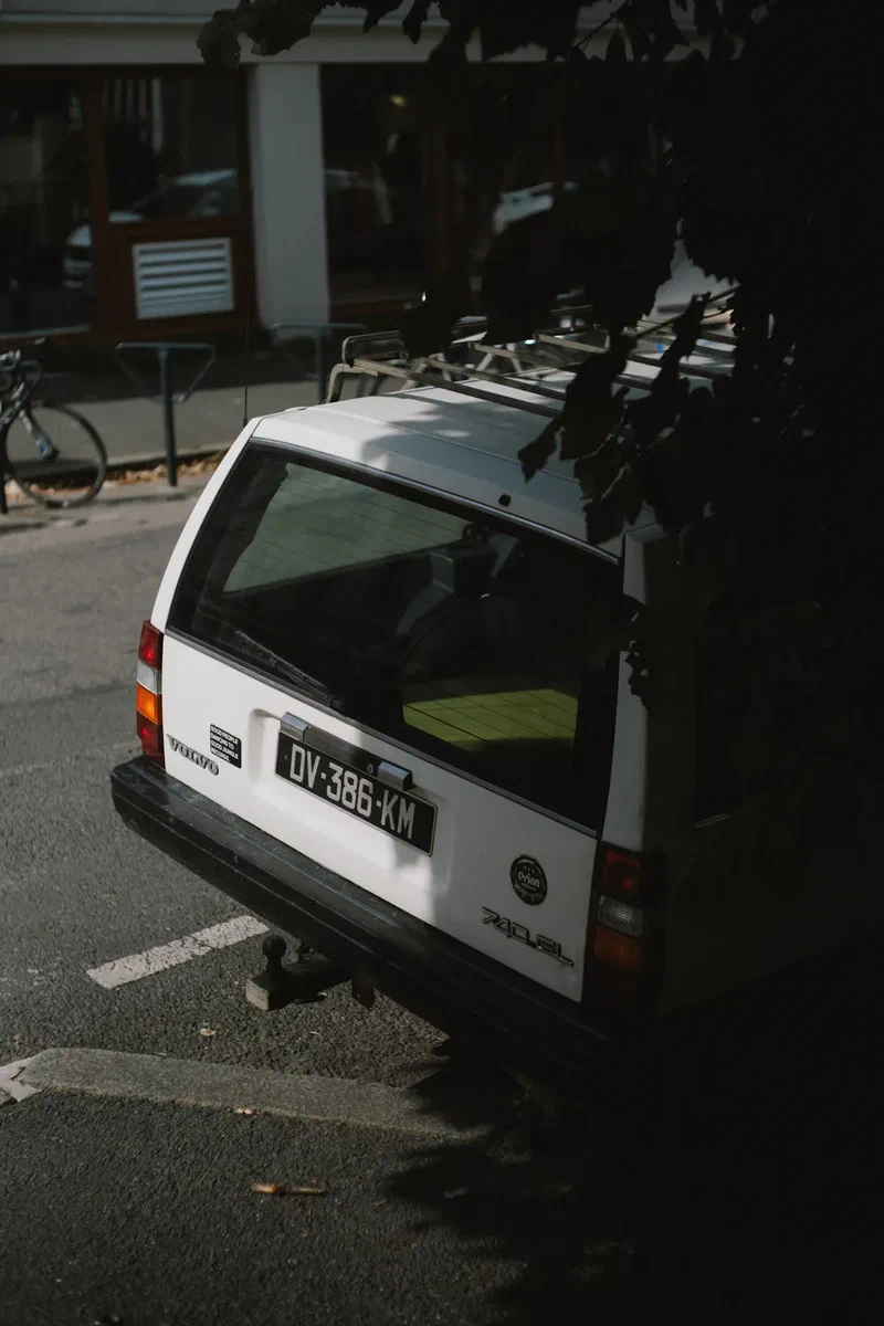 White vintage Volvo estate parked in the shade