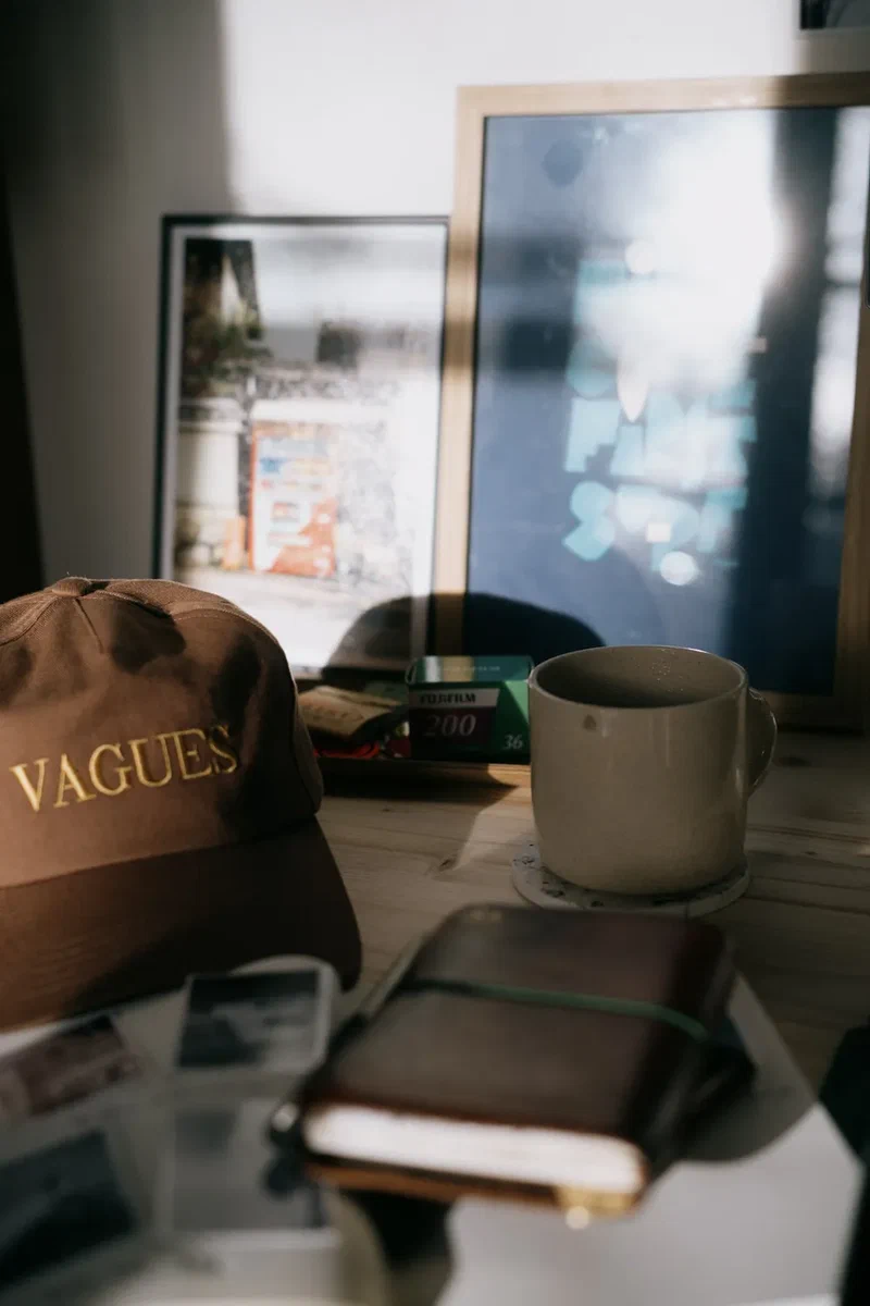 Vagues cap, notebook and mug on a desk