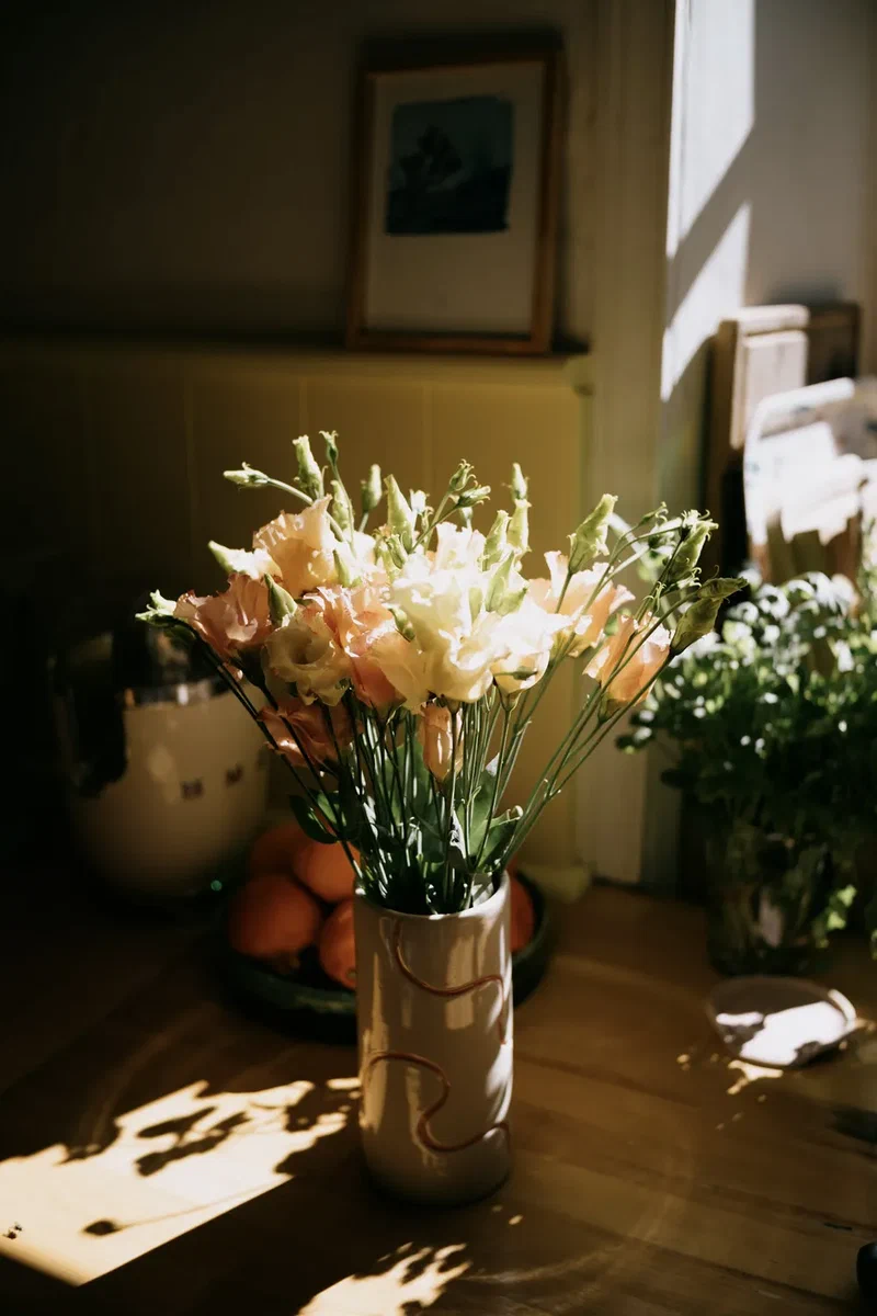 Bouquet of lilies on a table in the afternoon sun