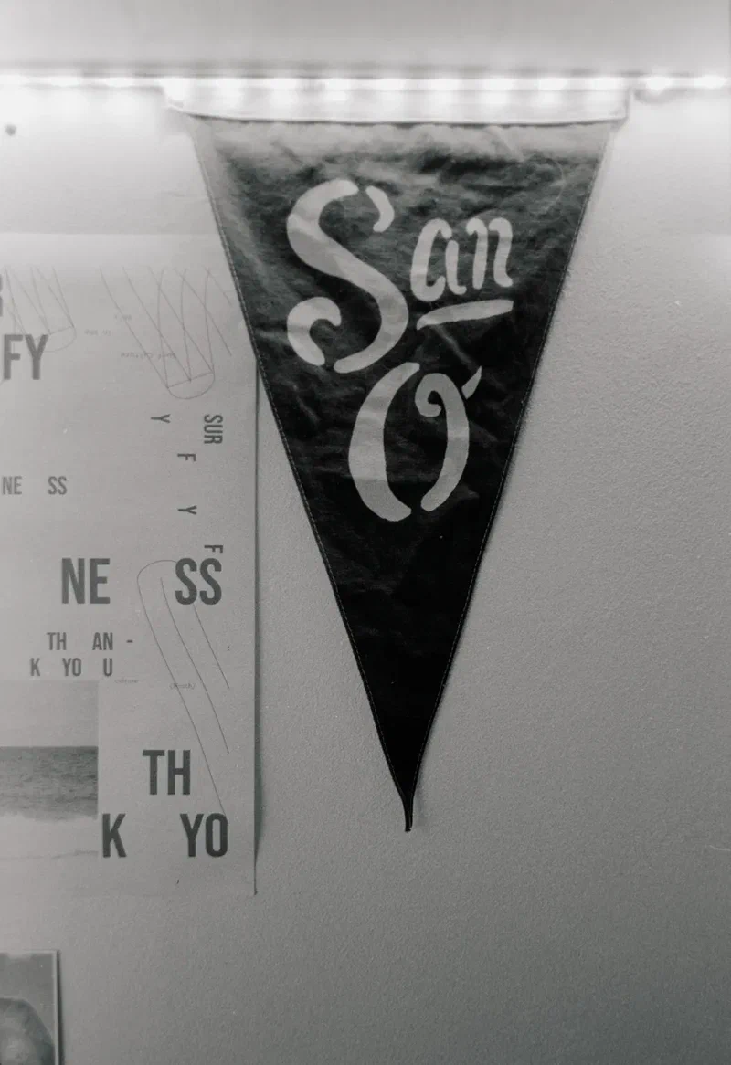 San O pennant on a white wall, black and white