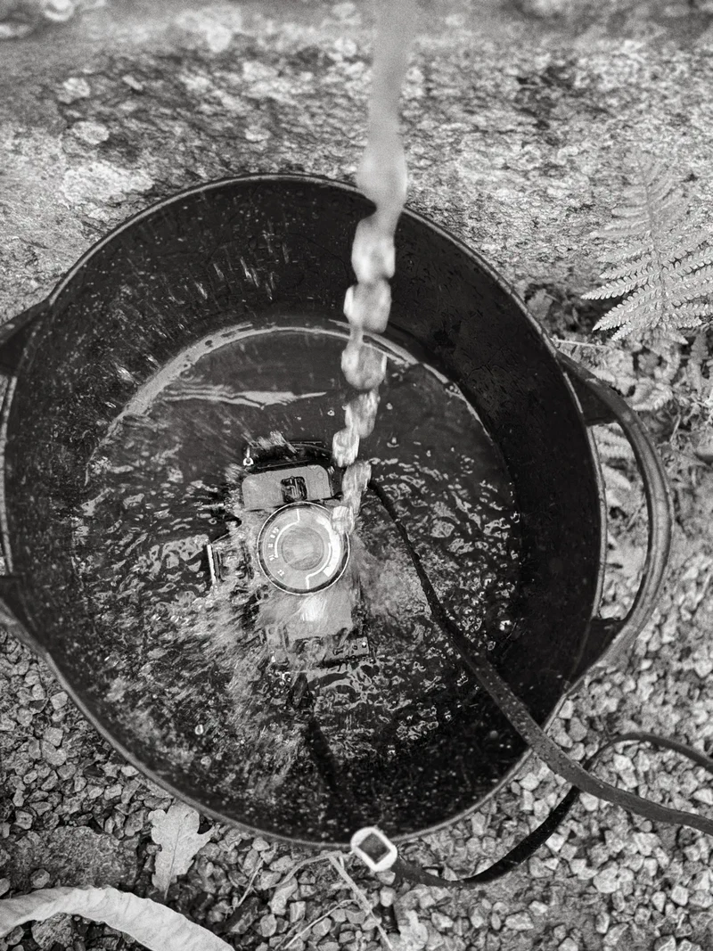 Camera in a bucket of water, seen from above, black and white