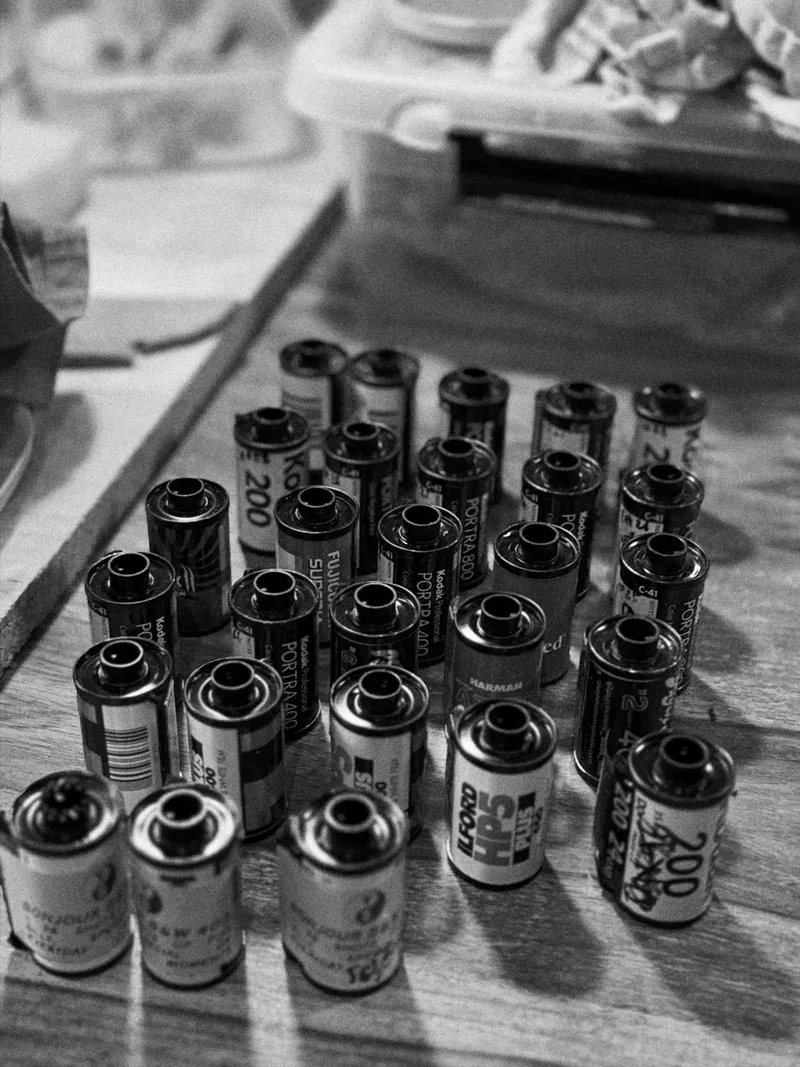 Pile of 35mm film canisters, black and white